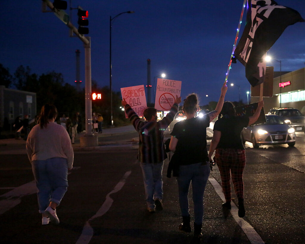 Demonstrators cross the intersection of Broadway Blvd. and Providence Rd. on on Wednesday in Columbia.